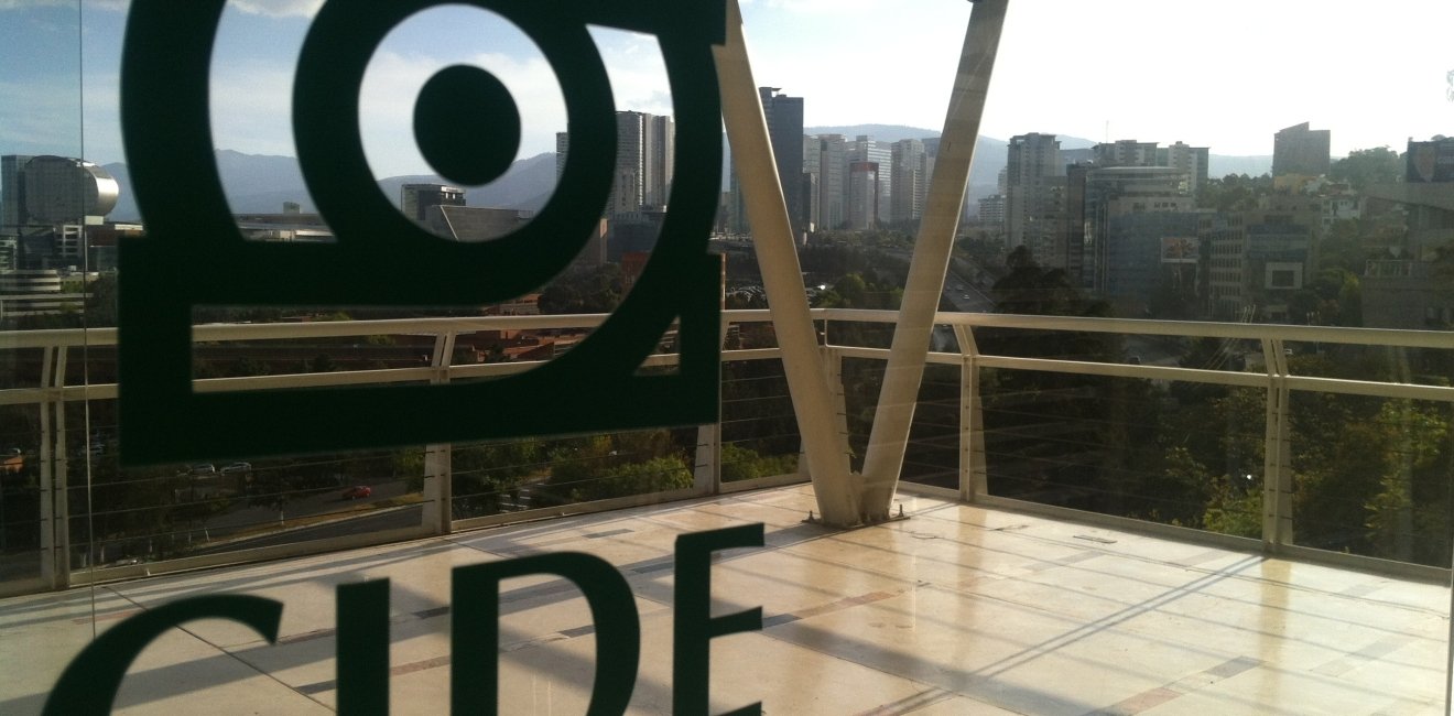 The CIDE logo on glass doors with Santa Fe in the distance