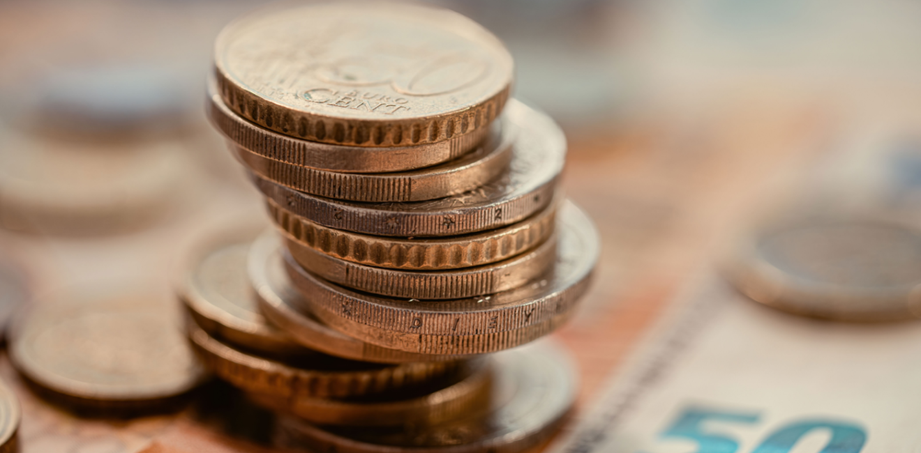 Euro coins on top of euro notes