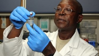 Biochemist looking at vial