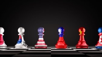 A set of chess pawns showing the flags of Japan, South Korea, The U.S., Taiwan, China, and North Korea