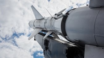 A military rocket pointed into a cloudy sky