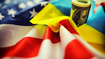 American and Ukrainian flags with a roll of American dollars
