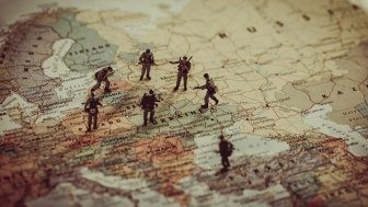 Toy soldiers stand on a map of Europe