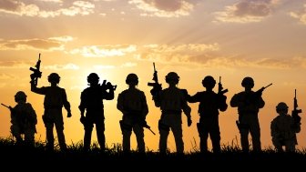 silhouette of Soldiers team with sunrise background