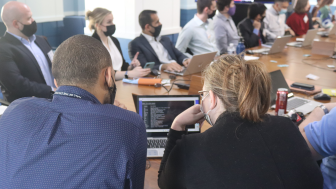 Two tech labs participants sharing a computer screen