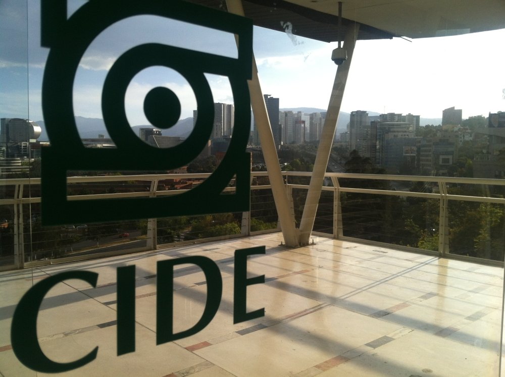 The CIDE logo on glass doors with Santa Fe in the distance