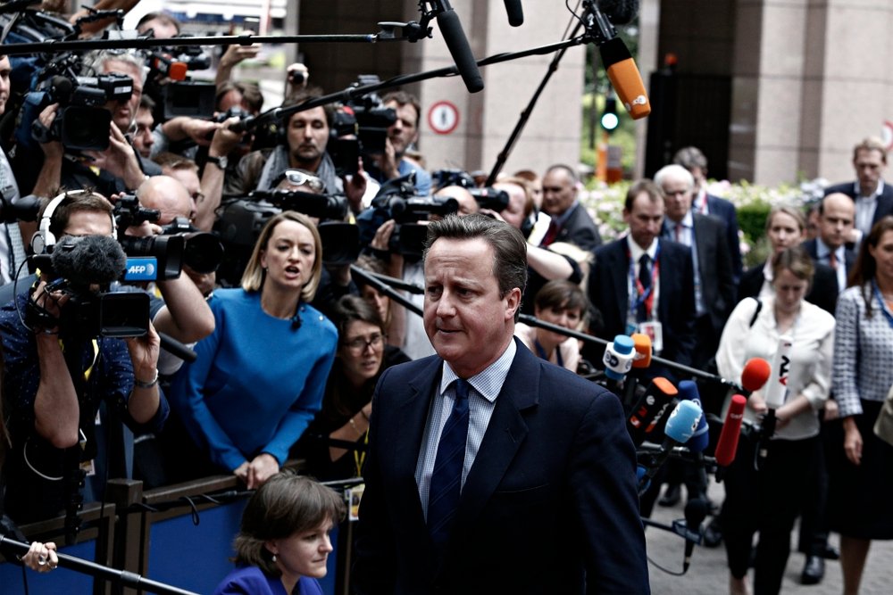 David Cameron speaking to reporters