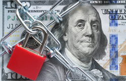 Photo of a lock and chain across a $100 bill