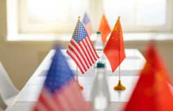 US and Chinese Flags Across a Table