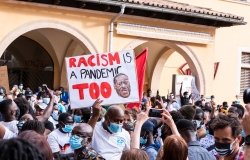 Palma de Mallorca, Spain - June 07 2020: Man surrounded by crowd holding a banner