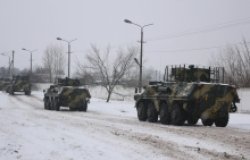 Kharkiv, Ukraine - January, 31, 2022: A column of armored personnel carriers rides on a winter road.